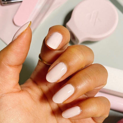 Hand displaying nails painted with GH, an opaque baby pink polish perfect for a radiant at-home manicure