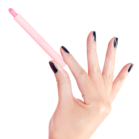 Cuticle Buffer held by hand with dark polished nails, designed for precise cuticle care in at-home mani routines
