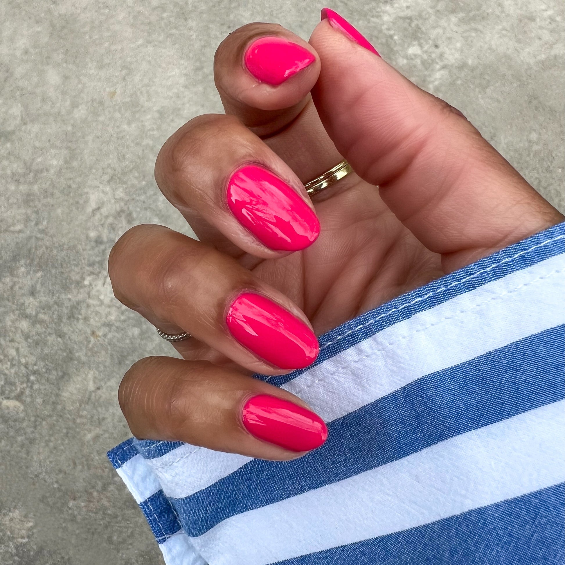 Diner Date hot pink gel polish on natural nails with a glossy finish for a vibrant and long-lasting manicure at home