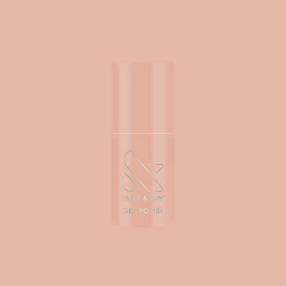 Bottle of KAG - Gel nail polish in neutral peachy pink shade on a matching soft peach background