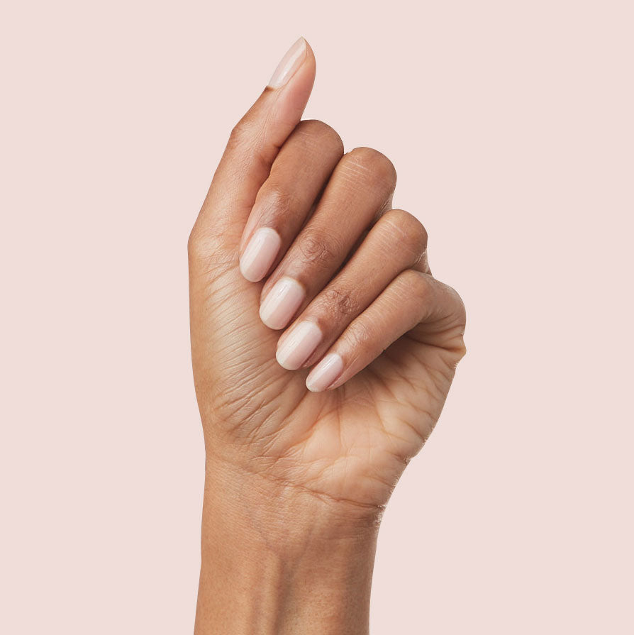 Hand showing nails polished in sheer neutral mauve using The Queen Takes her Tea with Milk for a natural manicure