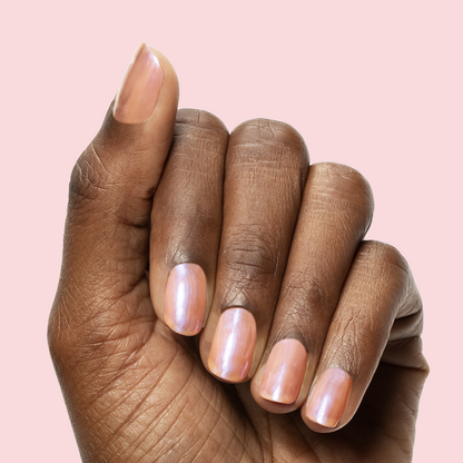 Hand with medium nails painted in sheer bubble gum pink-blue iridescent Olive Y'all gel polish manicure