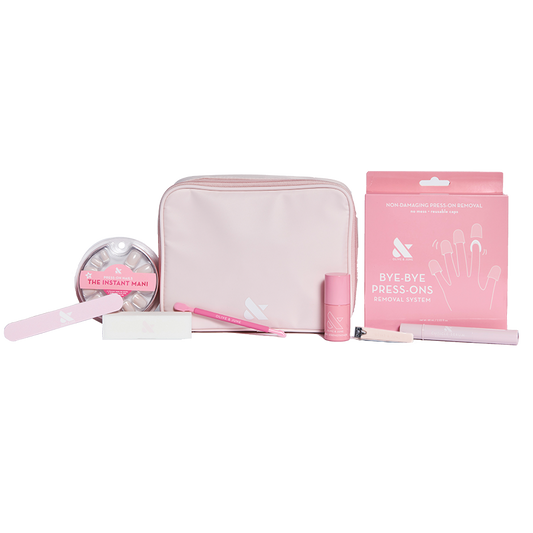 Press-On System - 4 Sets displayed with pink pouch, nail file, remover kit, brush, and nail polish for easy at-home mani care